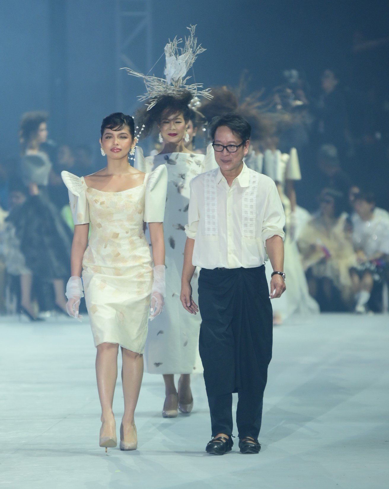 Fashion designer Jojie Lloren (right) and muses, TV personality Maine Mendoza (left) and model Jo Ann Bitagcol (back).